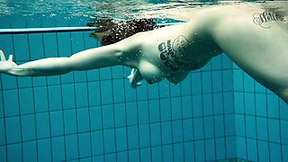Tattooed baby swirls underwater