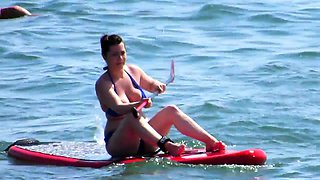 Busty amateur brunette in a sexy bikini enjoys the hot sun