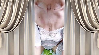 Cheerful Lukerya flirts in an open, transparent white jumpsuit in the kitchen