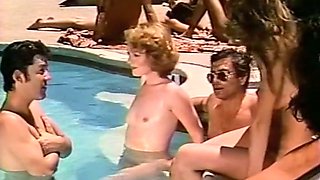 Several nude girls having sex fun in a pool one sunny day