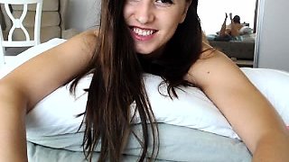 Beautiful camgirl sensually stripteases and rubs her pussy