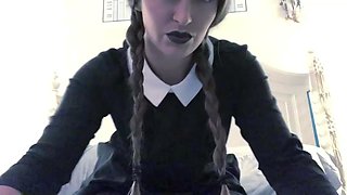 Braided woman in a black dress and pantyhose uses a fucktoy